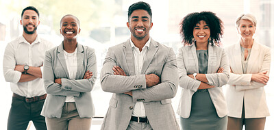 Buy stock photo Shot of a group of businesspeople standing with their arms crossed at work