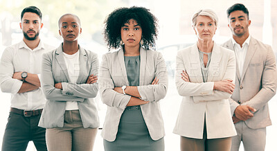 Buy stock photo Shot of a group of businesspeople standing with their arms crossed at work