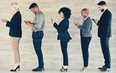 Buy stock photo Shot of a group of businesspeople waiting in line and using a phone at an office