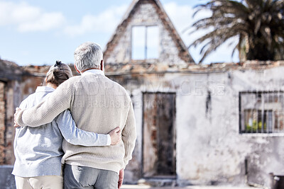 Buy stock photo Back, senior couple and building with disaster, hug and insurance for real estate or accident in home. Backyard, comfort and fire risk or problem with destruction and sad for loss, homeless or damage