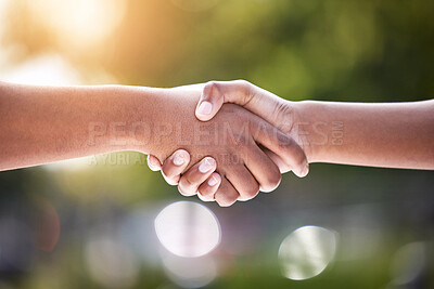 Buy stock photo Shot of two unrecognizable people shaking hands outside