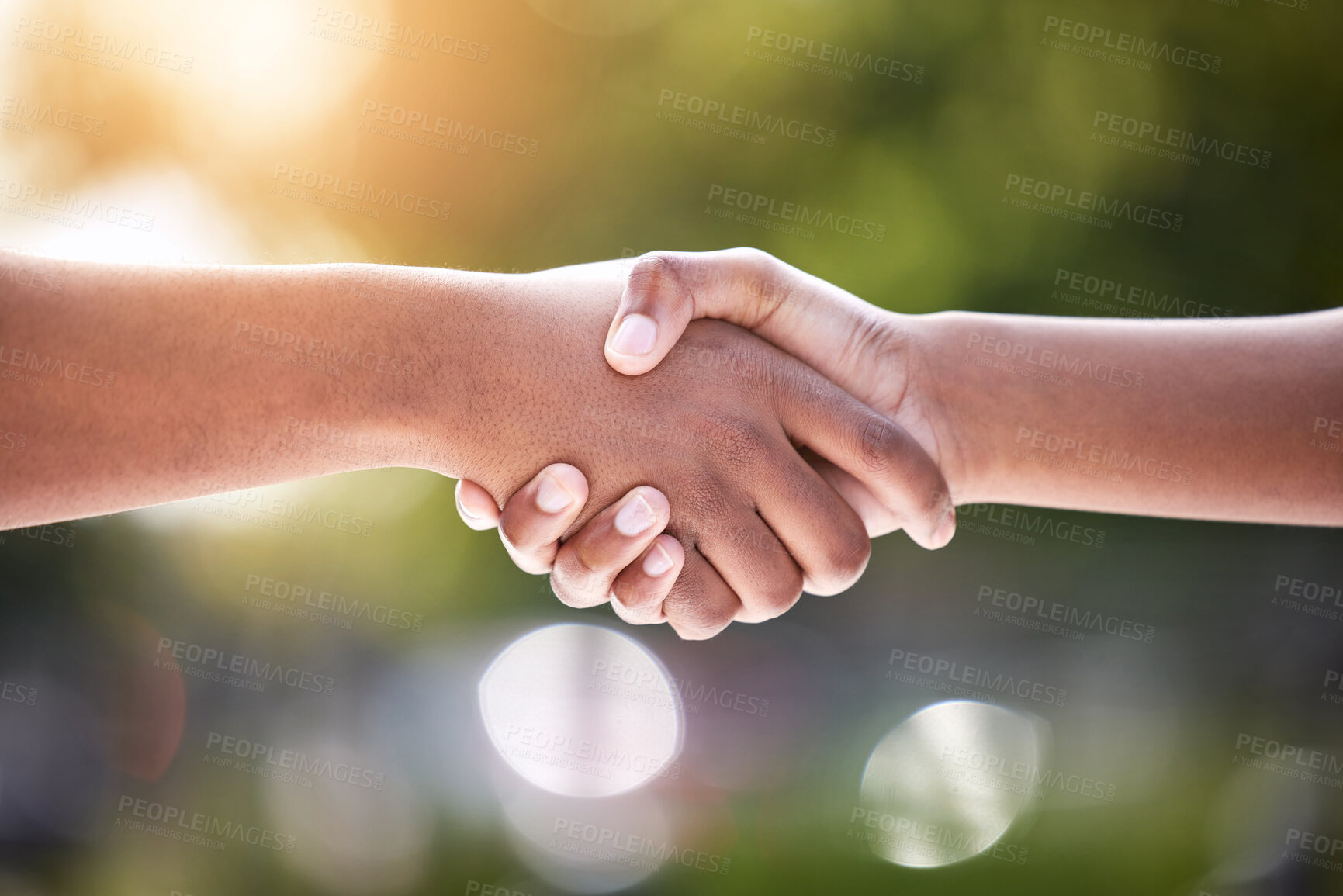 Buy stock photo Shot of two unrecognizable people shaking hands outside