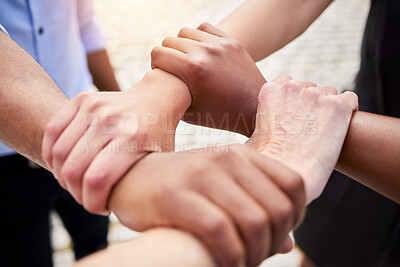 Buy stock photo Shot of a group of unrecognizable people holding each other's wrists outside