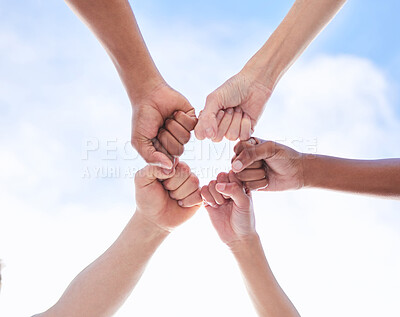 Buy stock photo Shot of a group of unrecognizable people making a circle with their fists outside