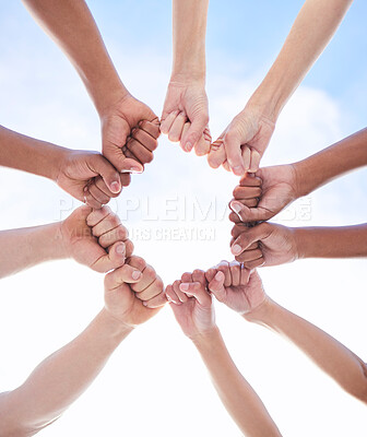 Buy stock photo Shot of a group of unrecognizable people making a circle with their fists outside