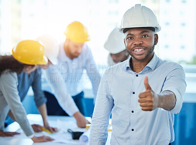 Buy stock photo Shot of a young businessman showing a thumbs up at work