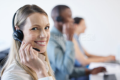 Buy stock photo Portrait of a mature businesswoman using a headset in a modern office with her team in the background