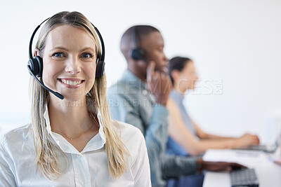 Buy stock photo Portrait of a mature businesswoman using a headset in a modern office with her team in the background