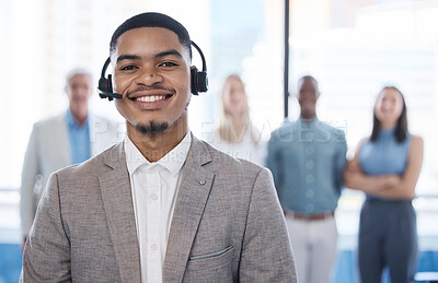 Buy stock photo Portrait of a young businessman using a headset in a modern office with his team in the background