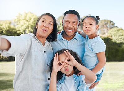 Buy stock photo Shot of a couple standing outside with their two daughters