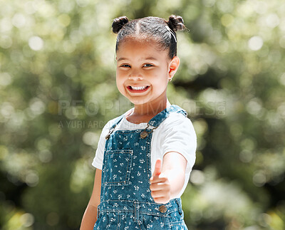 Buy stock photo Shot of an adorable little girl showing thumbs up while standing outside