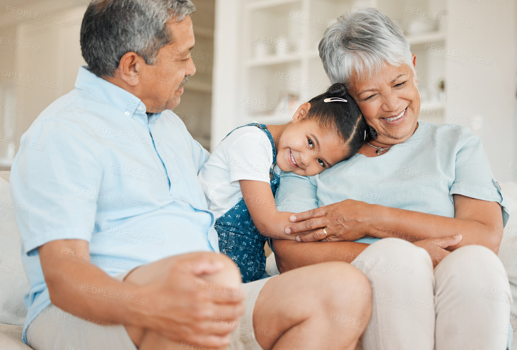 Buy stock photo Hug, family and smile in home, bonding and fun in living room on house sofa. Grandparents, couple and happy grandchild with grandmother and grandfather for love, relax and together in lounge