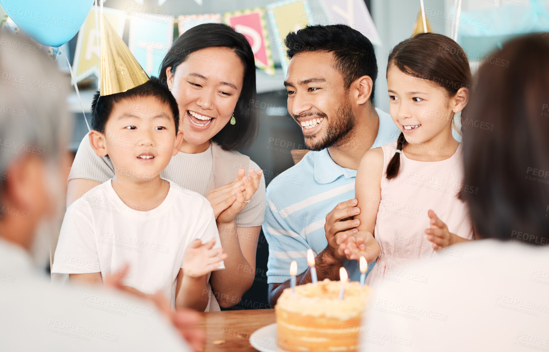 Buy stock photo Shot of a happy family celebrating a birthday at home