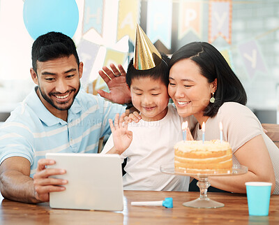 Buy stock photo Shot of a happy family using a tablet at home