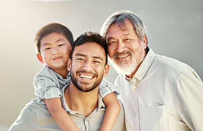 Buy stock photo Cropped portrait of a handsome young man on the beach with his father and son