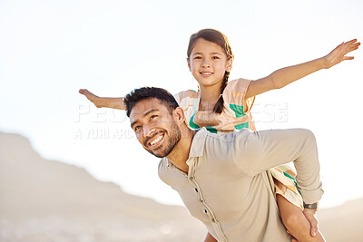 Buy stock photo Cropped shot of a handsome young man piggybacking his daughter on the beach