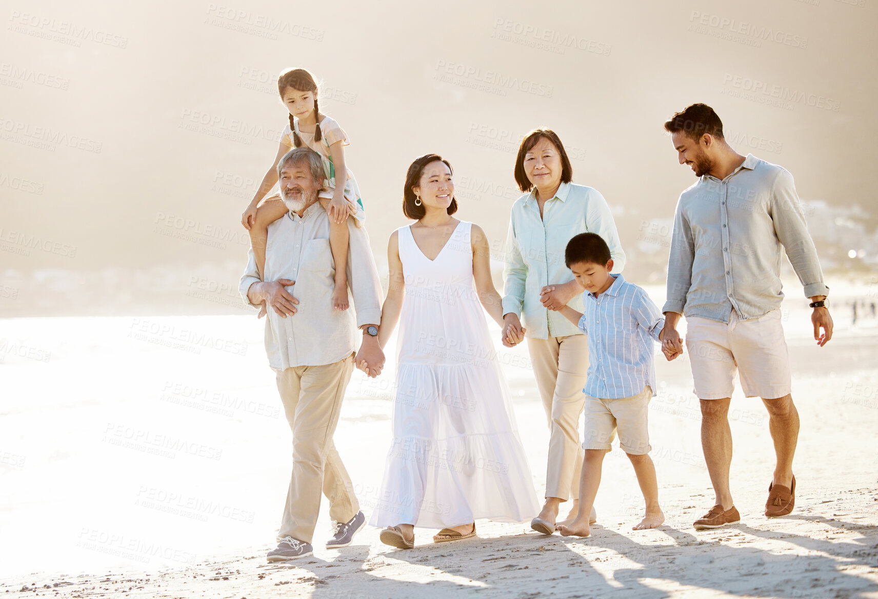 Buy stock photo Full length shot of a happy diverse multi-generational family at the beach