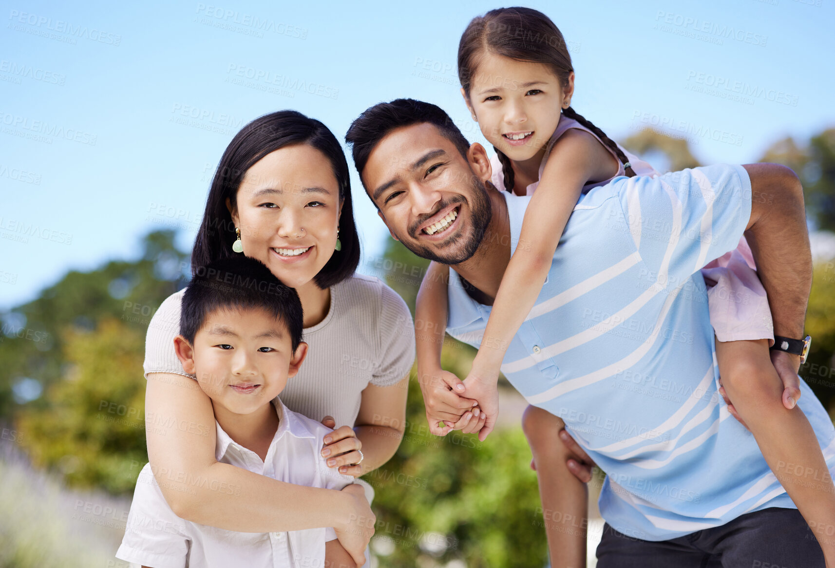 Buy stock photo Shot of a young family spending time together in their garden at home