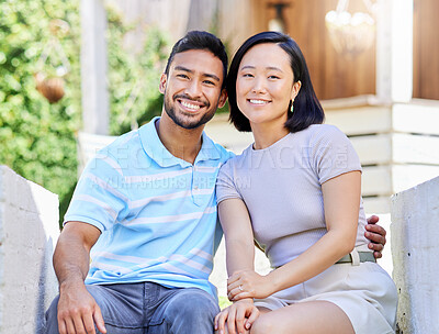Buy stock photo Shot of a young couple spending time together in the garden at home