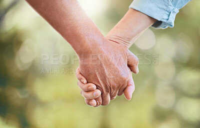 Buy stock photo Shot of an unrecognisable senior couple holding hands in a garden