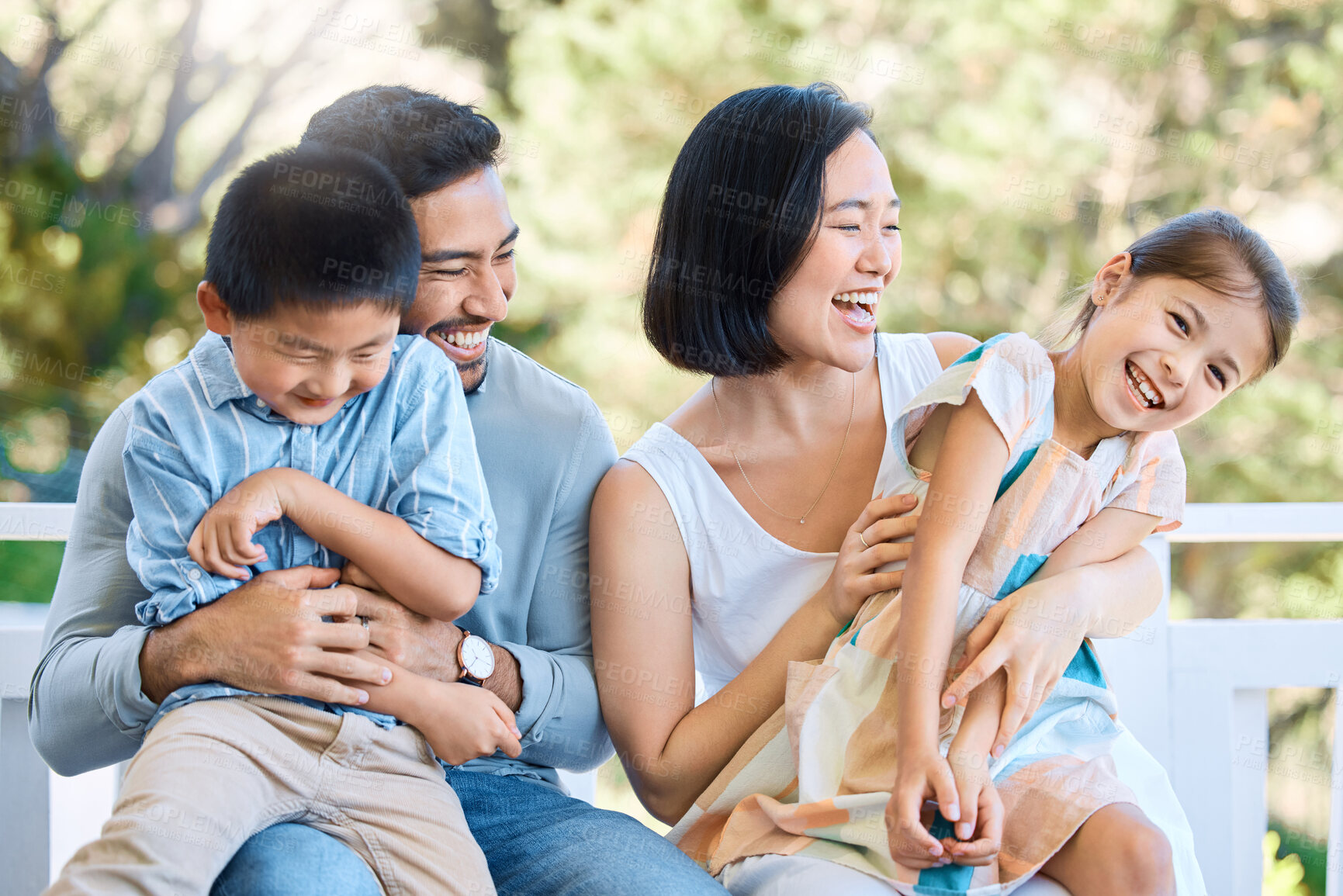 Buy stock photo Shot of a happy young family having a fun day in the park