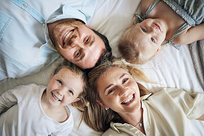 Buy stock photo Portrait, happy and children with parents on bed for bonding, security and having fun together. Relax, home and girl kids laying with mom and dad for resting in bedroom at house in London from above.