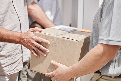 Buy stock photo Cropped shot of an unrecognizable male courier handing a package to a customer while out making deliveries