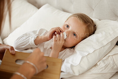 Buy stock photo Shot of a little girl feeling ill in bed at home and blowing her nose