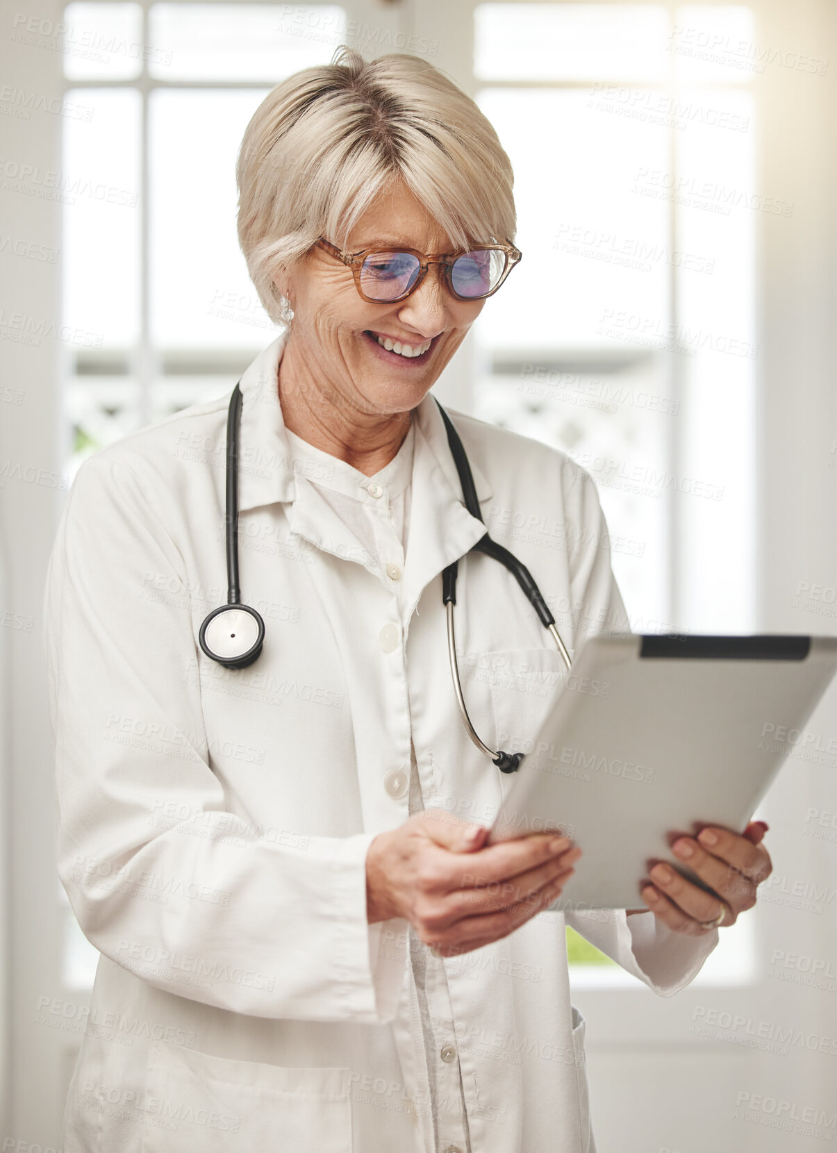 Buy stock photo Mature woman, doctor and tablet for reading in hospital with contact, notification or scroll on telehealth app. Person, smile and email on digital touchscreen, review or monkey pox research in clinic