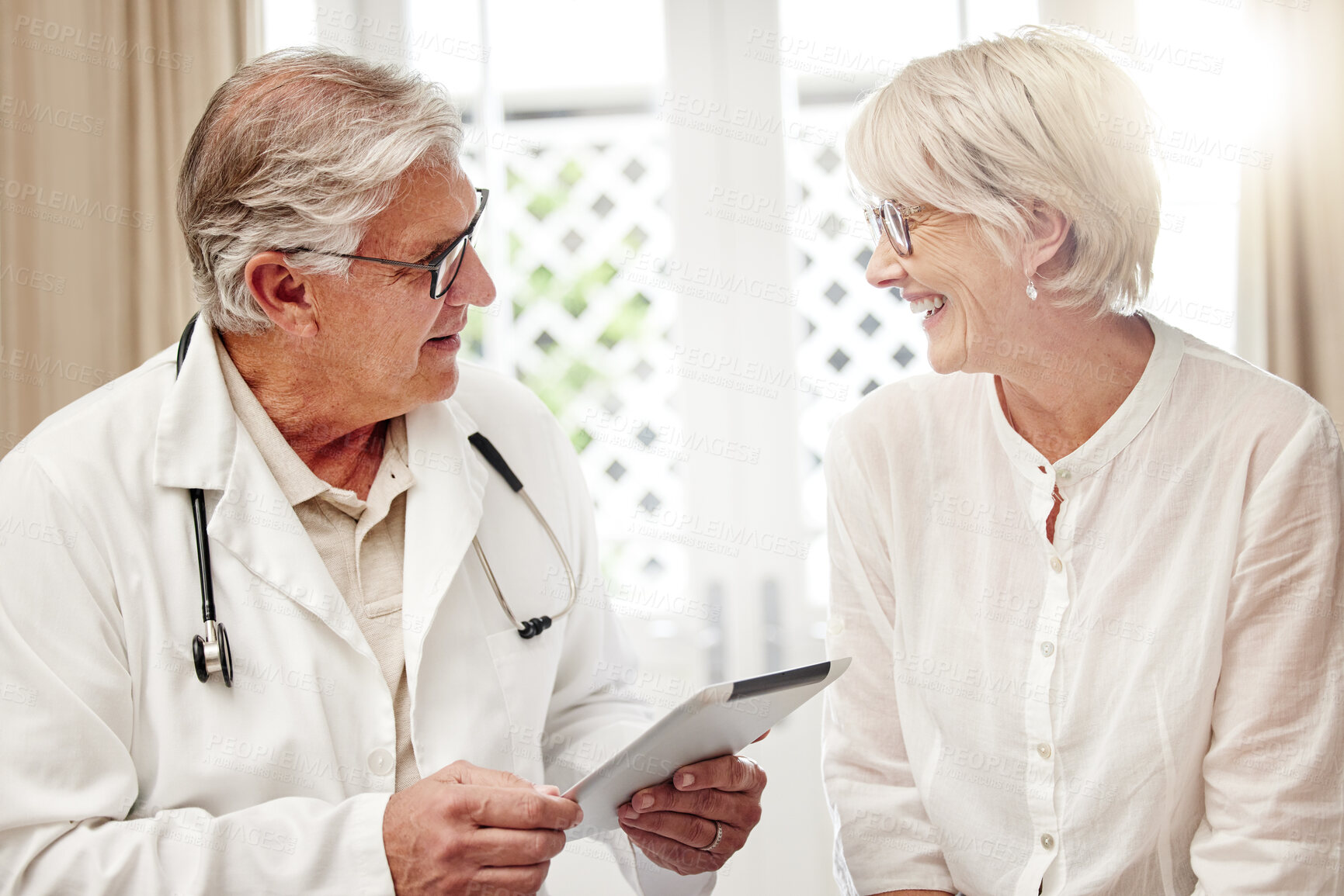 Buy stock photo Mature man, doctor and patient with tablet for checkup, visit or consultation on diagnosis at home. Senior, male person or medical professional talking to client with technology for health advice