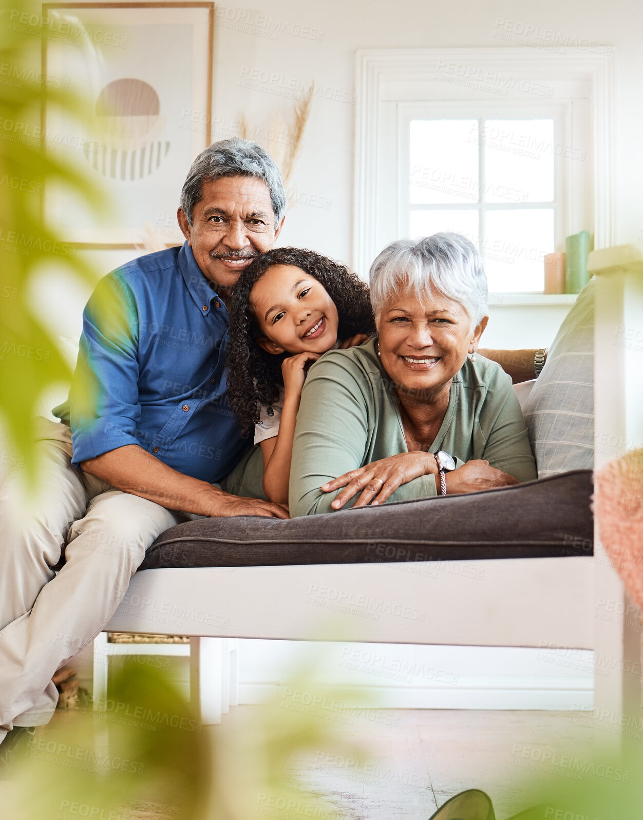 Buy stock photo Shot of a grandchild spending time with her grandparents at home