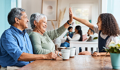 Buy stock photo Shot of a grandchild giving her grandmother a high five at home