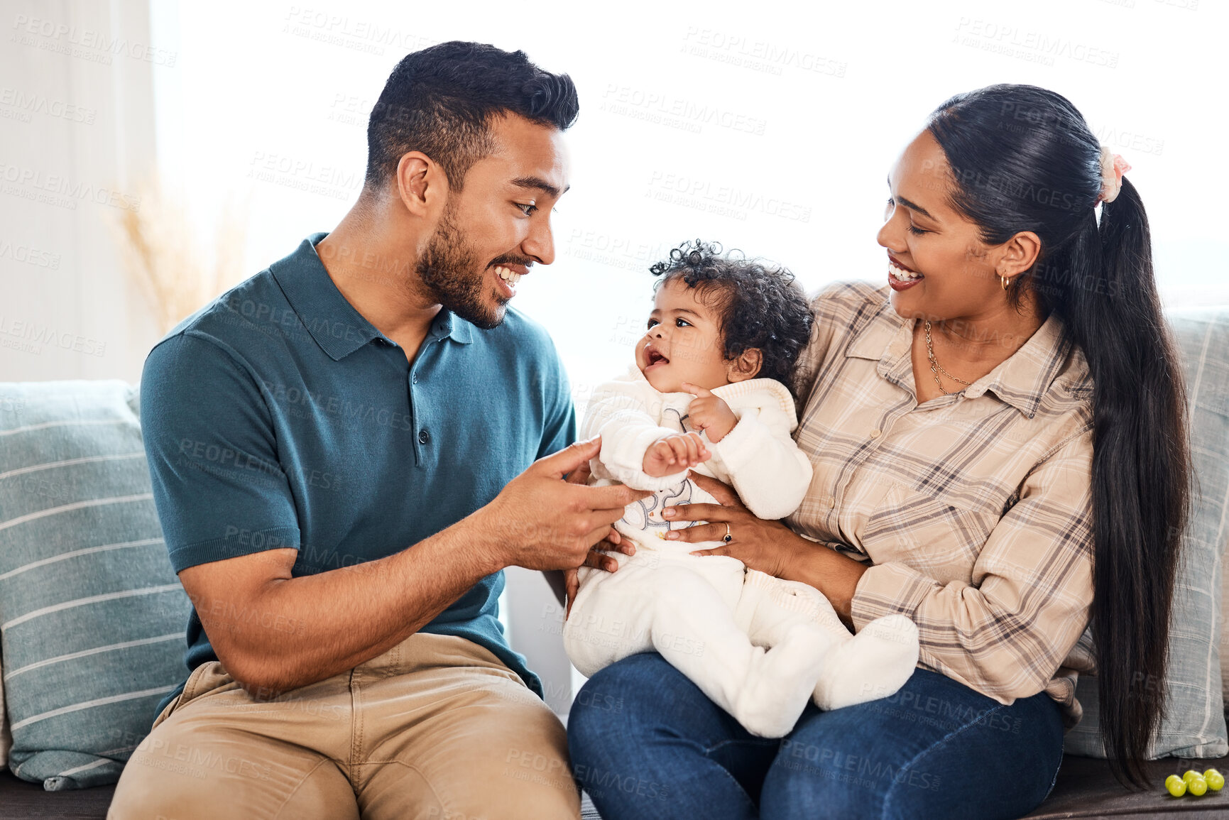 Buy stock photo Shot of a young family spending time together at home