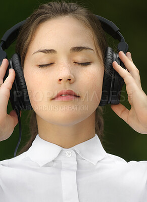 Buy stock photo Relax, woman or headphone for music, radio or streaming for zen outdoor in environment. Eyes closed, student or technology for audio, sound or listening in nature, garden or backyard in London