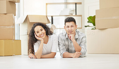 Buy stock photo Shot of a young couple taking a break from unpacking in their new homes