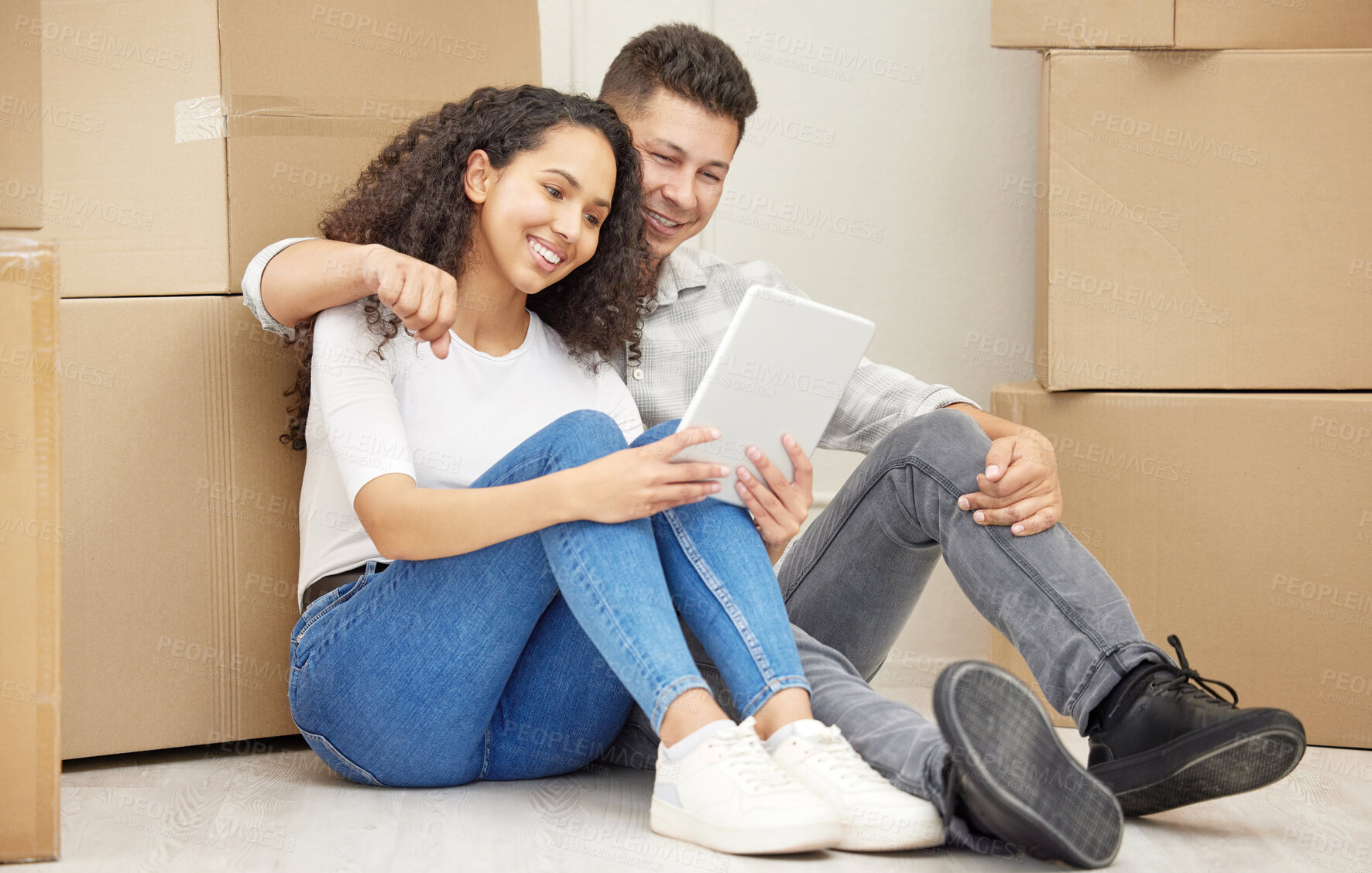 Buy stock photo Tablet, boxes and couple on floor in new home for property investment and mortgage approval. Happy, moving and people with digital technology for planning rental apartment layout online together.