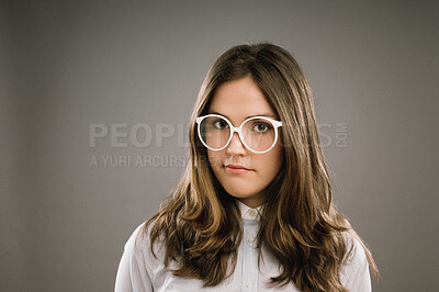 Buy stock photo Glasses, hair and portrait of girl nerd in studio on gray background for accessories or fashion. Face, intelligence and vision with cute geek or natural person in eyewear for retro or vintage style