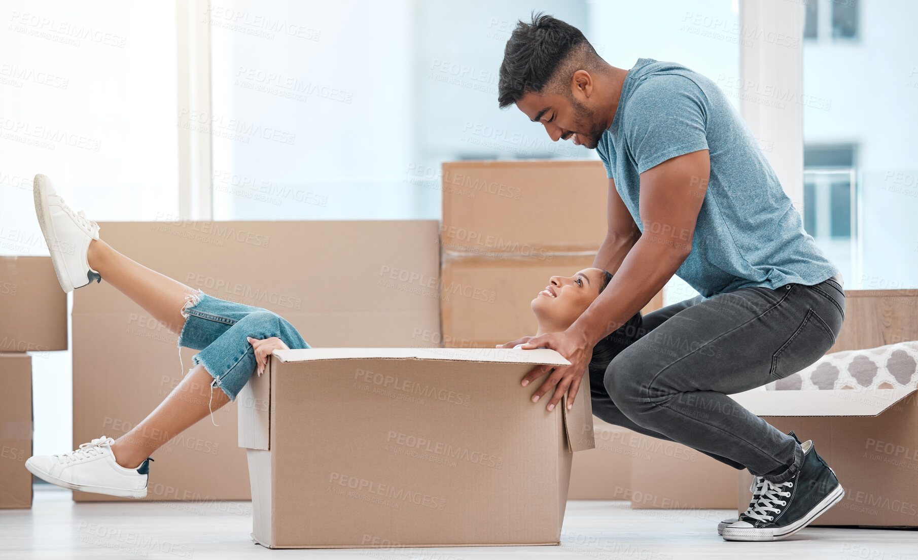 Buy stock photo Happy couple, play and cardboard box for new house, moving and real estate celebration, investment and excited game. Man, woman or people for fun in boxes while relocating into property home together