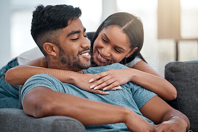 Buy stock photo Couple, hugging and smile on sofa in home living room, bonding, relaxing and having fun. Support, man and woman on couch embrace in lounge for relaxation, happiness or enjoying love together in house