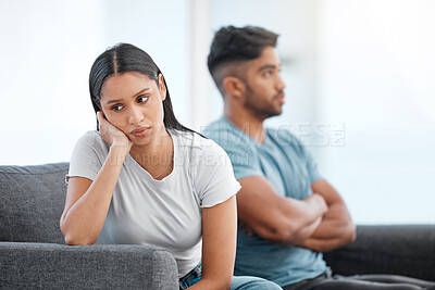 Buy stock photo Couple, fight and woman feeling sad and depressed on living room sofa with relationship problem. Divorce talk, cheating anxiety and marriage crisis of young people on a lounge couch at home thinking