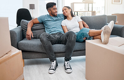 Buy stock photo Full length shot of a young couple sitting on the sofa in their new home