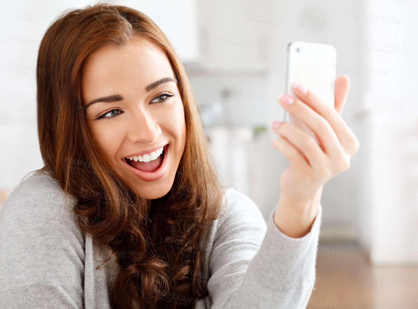 Buy stock photo Woman taking selfie on mobile phone, communication with people on social media and relax with smile and internet on technology at home. Fun, comic and silly girl in conversation on smartphone call