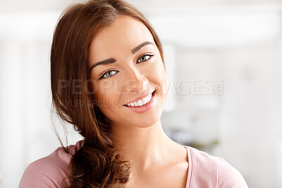 Buy stock photo Portrait of a happy, beautiful and young woman relaxing in her living room at her modern house. Smile, happiness and comfortable housewife sitting at home with a relax, luxury and calm lifestyle.