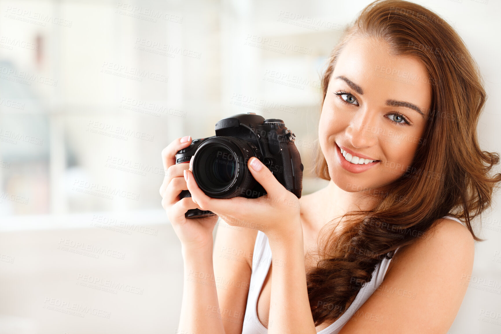 Buy stock photo Photographer, digital camera and photography with a woman taking a photograph or picture inside. Portrait of a young female with a smile holding photo gear for a beauty shoot with a happy model