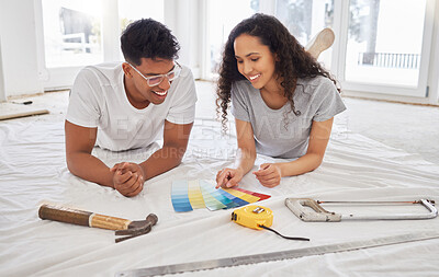 Buy stock photo Paint, renovation and choice with a couple in their new home together for a remodeling project. Construction, real estate or property improvement with a man and woman looking at a color pallet