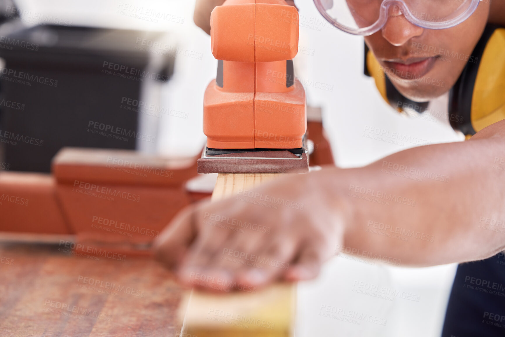 Buy stock photo Shot of a carpenter sanding a wood project