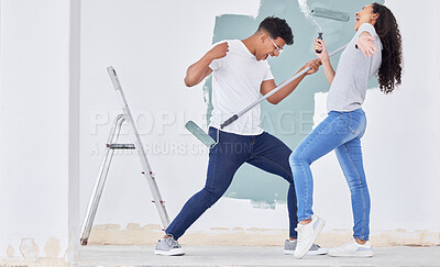 Buy stock photo Shot of a young couple dancing while busy painting a room