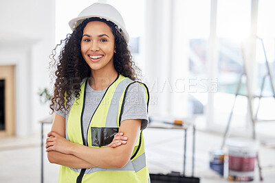 Buy stock photo Shot of an attractive young contractor standing alone inside with her arms folded