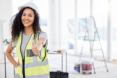 Buy stock photo Shot of an attractive young contractor standing alone inside and showing a thumbs up