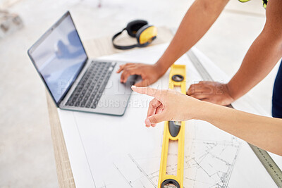 Buy stock photo Cropped shot of two unrecognisable contractors standing inside together and using a laptop while planning